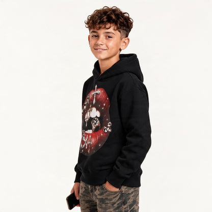 Ragazzo indossa felpa nera Chulo Store con stampa grafica di labbra rosse e croci gioiello, stile streetwear.